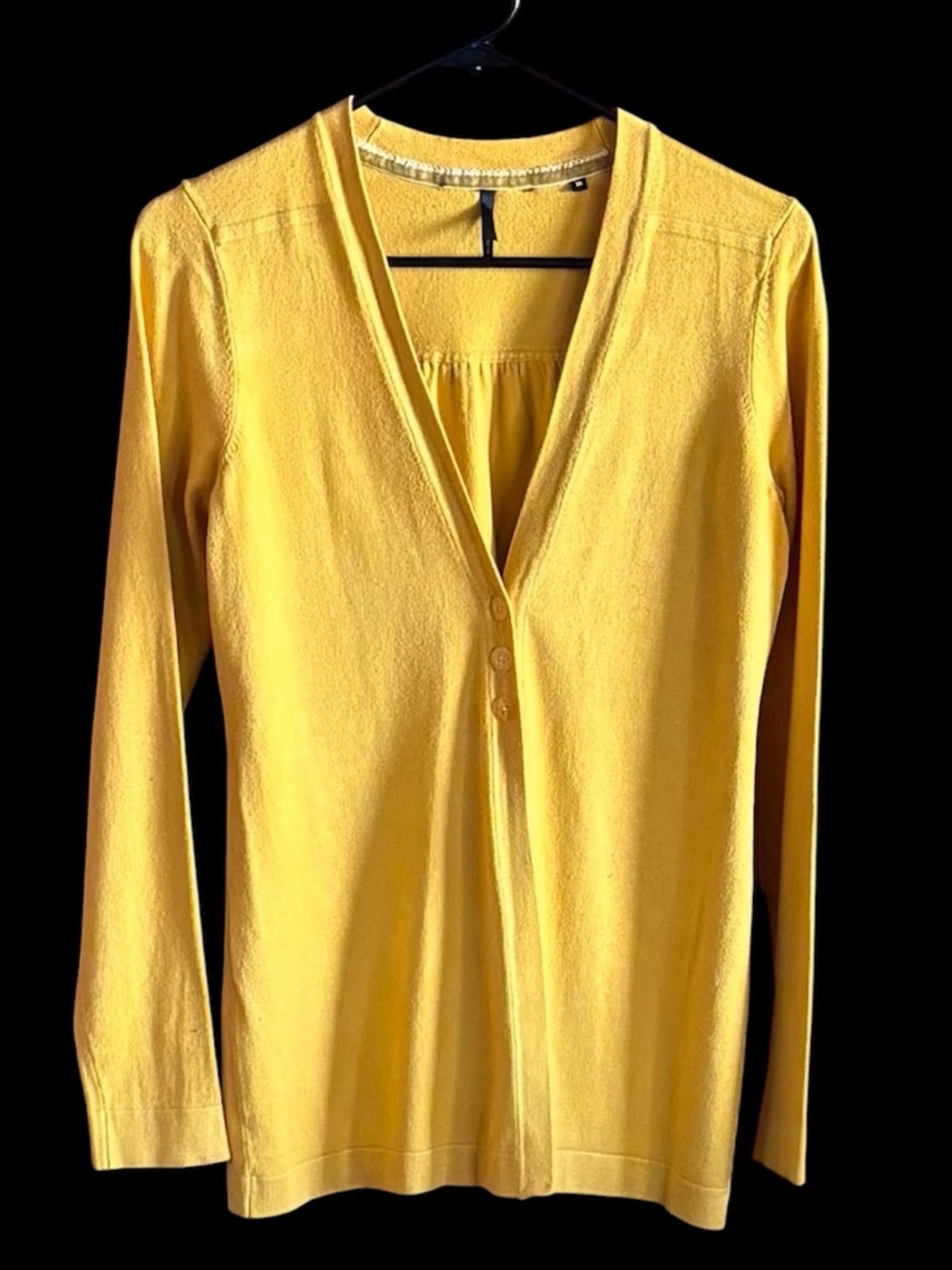 Women's mustard yellow v-neck cardigan sweater open in the front with 3 buttons